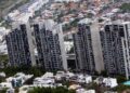 Vivienda-insostenible-nl - Los Industriales Bird's-eye View of a Cluster of Tall Concrete Apartment Towers Amid a Dense Hillside Cityscape with Low-rise Houses Surrounding Them - Los Industriales